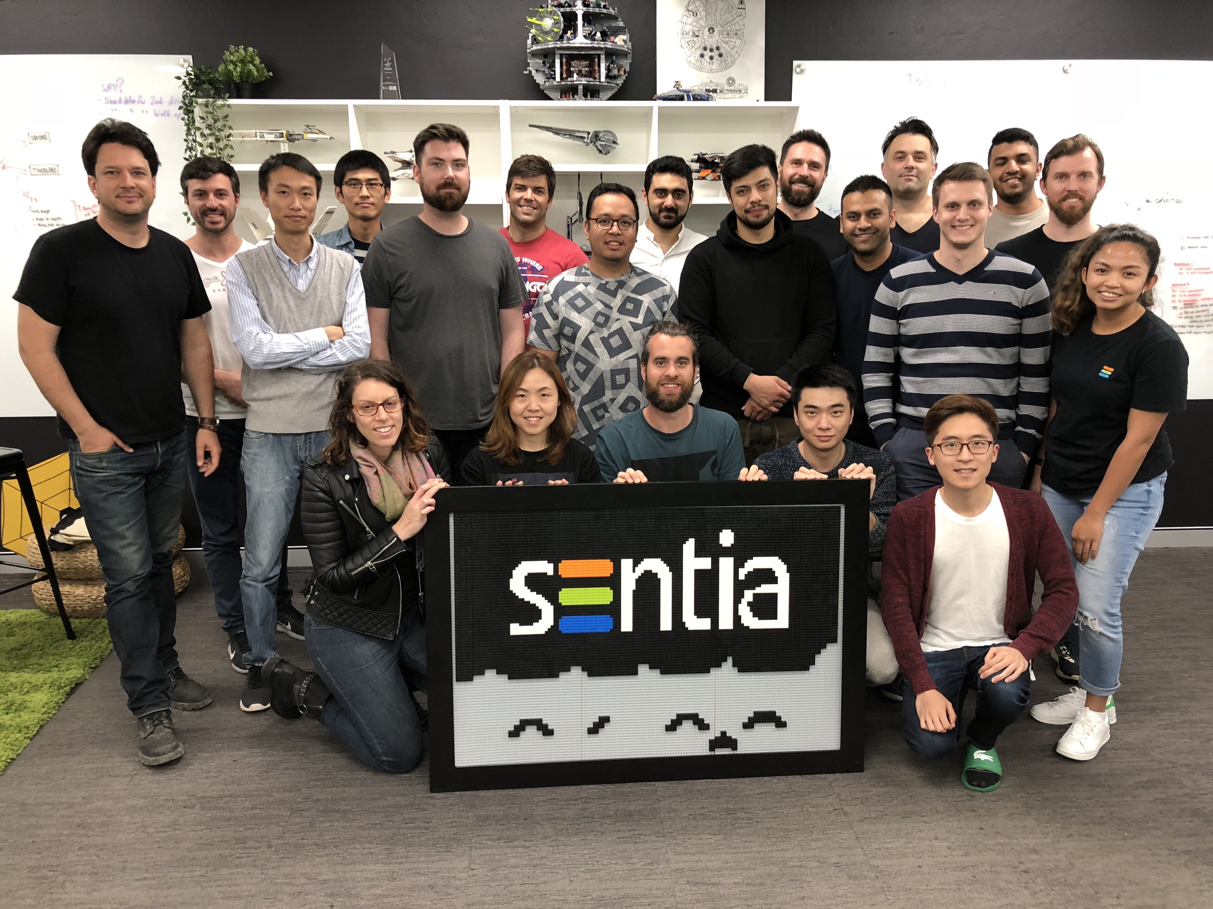 Sentia team group photo with a Lego Sentia logo